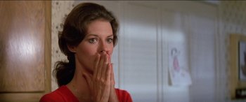 Movie still from “Poltergeist” (1982), directed by Tobe Hooper – A person covering her mouth with her hands; Close Up shot, Over the shoulder angle