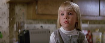 Movie still from “Poltergeist” (1982), directed by Tobe Hooper – A little girl with blonde hair and blue eyes looking at the camera; Close Up shot, Low angle