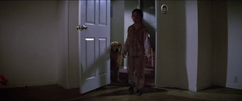 Movie still from “Poltergeist” (1982), directed by Tobe Hooper – A boy and a dog are standing in a room; Wide shot, High angle