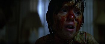 Movie still from “Poltergeist” (1982), directed by Tobe Hooper – A young girl is covered in blood in a dark room; Close Up shot, Low angle