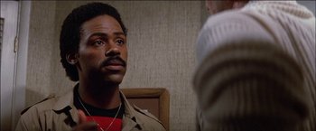 Movie still from “Poltergeist” (1982), directed by Tobe Hooper – A man in a brown jacket talking to another man in a brown jacket; Close Up shot, Over the shoulder angle