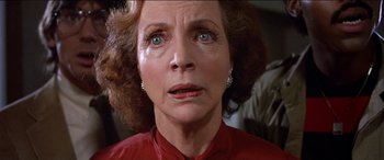 Movie still from “Poltergeist” (1982), directed by Tobe Hooper – An older woman with blue eyes looking at the camera; Close Up shot, Low angle