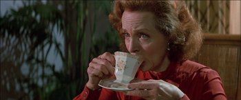 Movie still from “Poltergeist” (1982), directed by Tobe Hooper – A woman is drinking a cup of coffee; Close Up shot, High angle