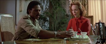 Movie still from “Poltergeist” (1982), directed by Tobe Hooper – A man and a woman sitting at a table; Medium shot, Low angle