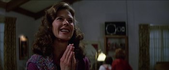 Movie still from “Poltergeist” (1982), directed by Tobe Hooper – A woman claps her hands while looking up at the ceiling; Close Up shot, Low angle