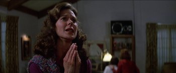 Movie still from “Poltergeist” (1982), directed by Tobe Hooper – A woman with her hands clasped in front of her face; Close Up shot, Low angle