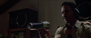 Movie still from “Poltergeist” (1982), directed by Tobe Hooper – A man holding a video game controller in his hand; Close Up shot, Low angle