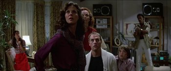 Movie still from “Poltergeist” (1982), directed by Tobe Hooper – A group of people standing in a living room; Medium shot, Low angle