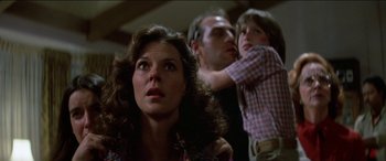 Movie still from “Poltergeist” (1982), directed by Tobe Hooper – A woman and a man and a little girl; Close Up shot, Low angle