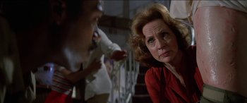 Movie still from “Poltergeist” (1982), directed by Tobe Hooper – An older woman sitting on the ground in front of a young child; Close Up shot, Over the shoulder angle