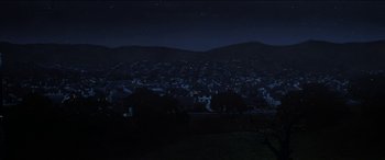 Movie still from “Poltergeist” (1982), directed by Tobe Hooper – A view of a city at night from a hill; Extreme Wide shot, High angle
