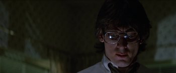Movie still from “Poltergeist” (1982), directed by Tobe Hooper – A man wearing glasses and a shirt and tie; Close Up shot, Low angle