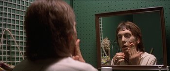 Movie still from “Poltergeist” (1982), directed by Tobe Hooper – A man looking at himself in the mirror in front of a bathroom mirror; Close Up shot, Over the shoulder angle