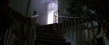 Movie still from “Poltergeist” (1982), directed by Tobe Hooper – A staircase that has a railing that has a railing on it; Wide shot, Low angle