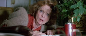Movie still from “Poltergeist” (1982), directed by Tobe Hooper – An older woman is looking at a computer screen; Close Up shot, Low angle