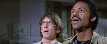 Movie still from “Poltergeist” (1982), directed by Tobe Hooper – A man with glasses and a man with a mustache; Close Up shot, Low angle