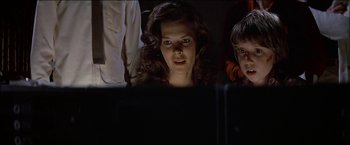 Movie still from “Poltergeist” (1982), directed by Tobe Hooper – A woman and a child looking at a computer screen; Close Up shot, Low angle