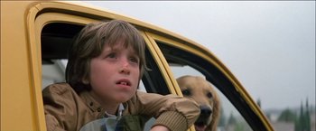 Movie still from “Poltergeist” (1982), directed by Tobe Hooper – A boy and a dog in a yellow car; Close Up shot, Low angle