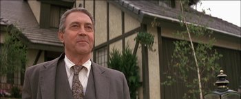 Movie still from “Poltergeist” (1982), directed by Tobe Hooper – A person wearing a suit and tie; Close Up shot, Low angle