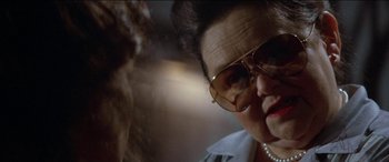 Movie still from “Poltergeist” (1982), directed by Tobe Hooper – An older woman wearing a pair of sunglasses; Close Up shot, Low angle