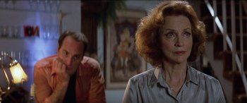 Movie still from “Poltergeist” (1982), directed by Tobe Hooper – An older woman is looking at a man in a room; Close Up shot, Low angle