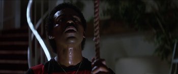 Movie still from “Poltergeist” (1982), directed by Tobe Hooper – A man holding a rope in a dark room; Close Up shot, Low angle