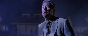 Movie still from “Poltergeist” (1982), directed by Tobe Hooper – An older man wearing a suit and tie looking up; Close Up shot, Low angle
