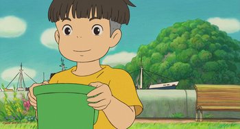 Movie still from “Ponyo” (2008), directed by Hayao Miyazaki – A cartoon of a boy holding a green bag; Close Up shot, Low angle