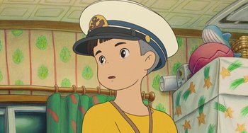 Movie still from “Ponyo” (2008), directed by Hayao Miyazaki – A boy wearing a sailor's hat in a room with green walls; Close Up shot, Over the shoulder angle