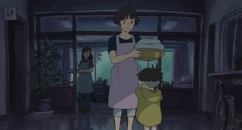 Movie still from “Ponyo” (2008), directed by Hayao Miyazaki – A woman and a child are standing in a room; Medium shot, Low angle