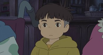 Movie still from “Ponyo” (2008), directed by Hayao Miyazaki – A boy is looking at the camera while wearing a yellow jacket; Close Up shot, High angle