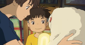 Movie still from “Ponyo” (2008), directed by Hayao Miyazaki – A boy and a woman are looking at a book; Close Up shot, Over the shoulder angle