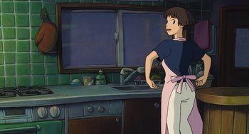 Movie still from “Ponyo” (2008), directed by Hayao Miyazaki – A woman standing in front of a sink in a kitchen; Medium shot, Low angle
