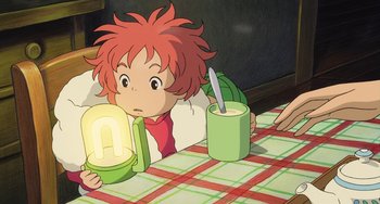 Movie still from “Ponyo” (2008), directed by Hayao Miyazaki – A child sitting at a table with a bowl of soup; Medium shot, High angle