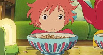 Movie still from “Ponyo” (2008), directed by Hayao Miyazaki – A child is sitting in front of a bowl of noodles; Close Up shot, High angle