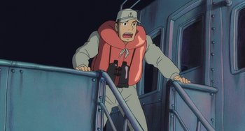 Movie still from “Ponyo” (2008), directed by Hayao Miyazaki – An animated man in a life jacket is standing on the stairs; Medium shot, High angle