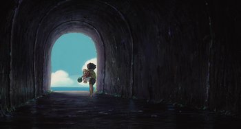 Movie still from “Ponyo” (2008), directed by Hayao Miyazaki – A child standing in front of an opening in a tunnel; Extreme Wide shot, Low angle