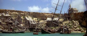 Movie still from “Popeye” (1980), directed by Robert Altman – A boat that is in the water; Extreme Wide shot, High angle