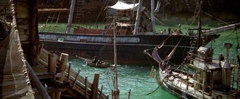 Movie still from “Popeye” (1980), directed by Robert Altman – Two boats in a body of green water; Extreme Wide shot, High angle