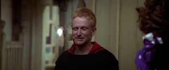 Movie still from “Popeye” (1980), directed by Robert Altman – A man with a pipe in his mouth; Close Up shot, Low angle