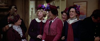 Movie still from “Popeye” (1980), directed by Robert Altman – A group of women dressed up for a party; Medium shot, High angle