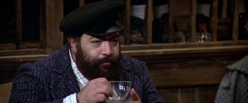Movie still from “Popeye” (1980), directed by Robert Altman – A man with a beard is holding a cup of tea; Close Up shot, Low angle