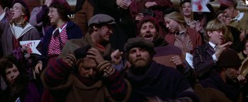 Movie still from “Popeye” (1980), directed by Robert Altman – A group of people that are sitting in a room; Medium shot, High angle