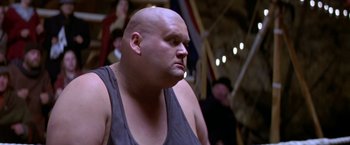 Movie still from “Popeye” (1980), directed by Robert Altman – A man with a bald head is looking at the camera; Close Up shot, Low angle