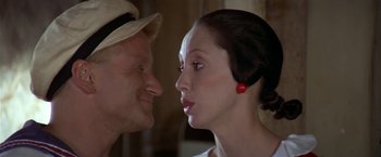 Movie still from “Popeye” (1980), directed by Robert Altman – A man and a woman face to face in front of each other; Close Up shot, Over the shoulder angle