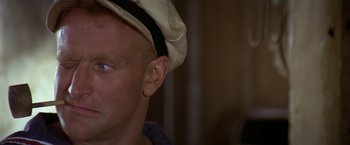 Movie still from “Popeye” (1980), directed by Robert Altman – A person wearing a hat; Close Up shot, Low angle