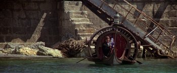 Movie still from “Popeye” (1980), directed by Robert Altman – A man and a child in a boat in the middle of the water; Wide shot, High angle