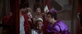 Movie still from “Popeye” (1980), directed by Robert Altman – A group of people dressed up in costumes; Medium shot, High angle