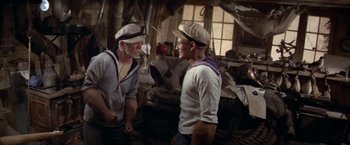 Movie still from “Popeye” (1980), directed by Robert Altman – Two men in sailor's outfits talking to each other; Medium shot, High angle