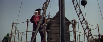 Movie still from “Popeye” (1980), directed by Robert Altman – A man holding a child on a boat; Wide shot, Low angle